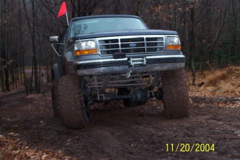 1995 Ford Bronco - This lifted 1995 Ford Bronco navigates a muddy, wooded path with a red flag on its antenna.