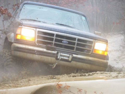 1995 Ford Bronco - This 1995 Ford Bronco is navigating a muddy off-road trail.