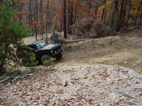 1995 Ford Bronco - This 1978 Ford Bronco navigates a challenging dirt trail surrounded by fall foliage.