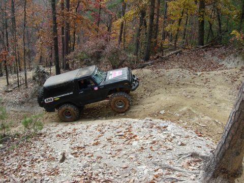1995 Ford Bronco - This modified SUV navigates a challenging off-road course during an autumn excursion.