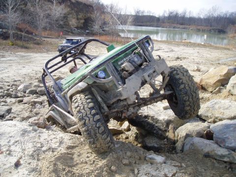 1992 Ford Bronco - A modified Suzuki Samurai navigates a rocky obstacle course with another vehicle in the background.