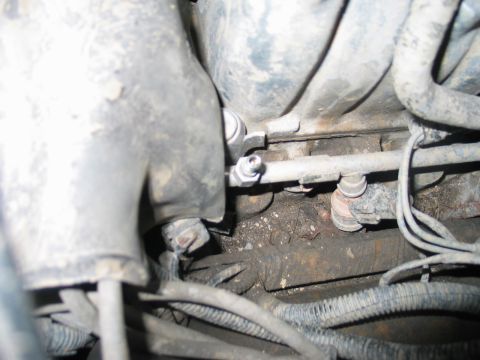 1995 Ford Bronco - Engine bay fuel line and fittings, showing dirt and grime.
