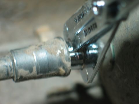 1995 Ford Bronco - Close-up of a wrench working on a pipe fitting, likely part of a vehicle's fuel system.