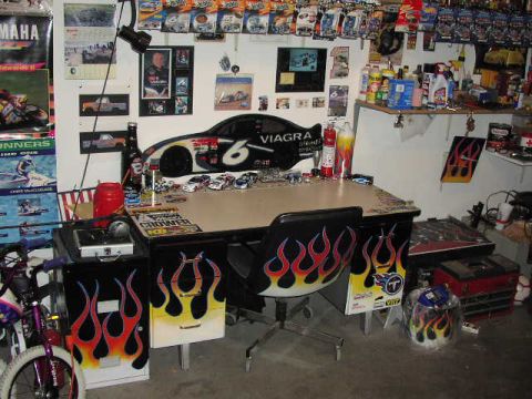 1981 Ford Bronco - A room filled with racing memorabilia, model cars, and a desk covered in various items.