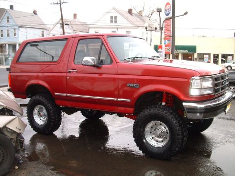 1994 Ford Bronco - This red 1994 Ford Bronco features a lifted suspension and aftermarket wheels.