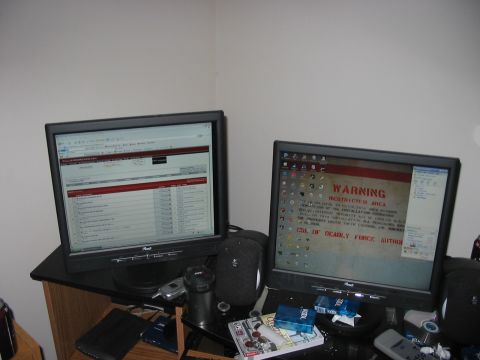 1988 Ford Bronco - A desk setup with two monitors displaying different content, including a warning sign on the right screen.