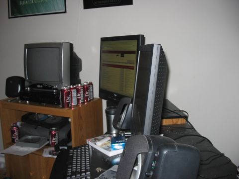 1988 Ford Bronco - A desk setup with multiple computer monitors, a keyboard, and several cans of Dr. Thunder soda.