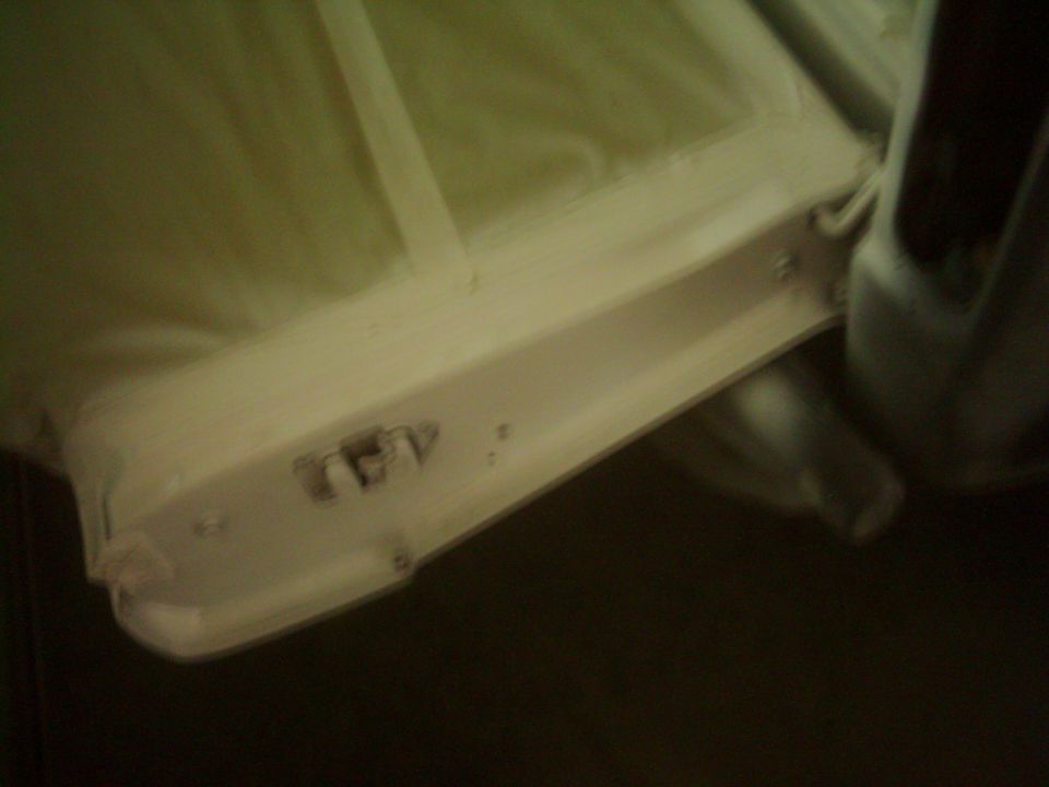 Interior door panel with visible latch mechanism and trim