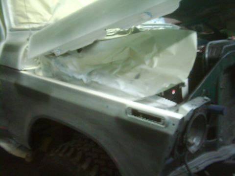 1978 Ford Bronco - The vehicle's engine bay is covered with protective sheeting during bodywork.