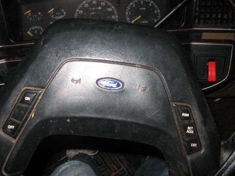1988 Ford Bronco - Interior view of a 1988 Ford Bronco, showing the steering wheel with Ford emblem and the instrument cluster.
