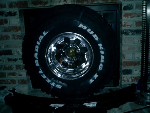 1990 Ford Bronco - A Mud King XT tire with a chrome rim is shown, likely for a truck or SUV.