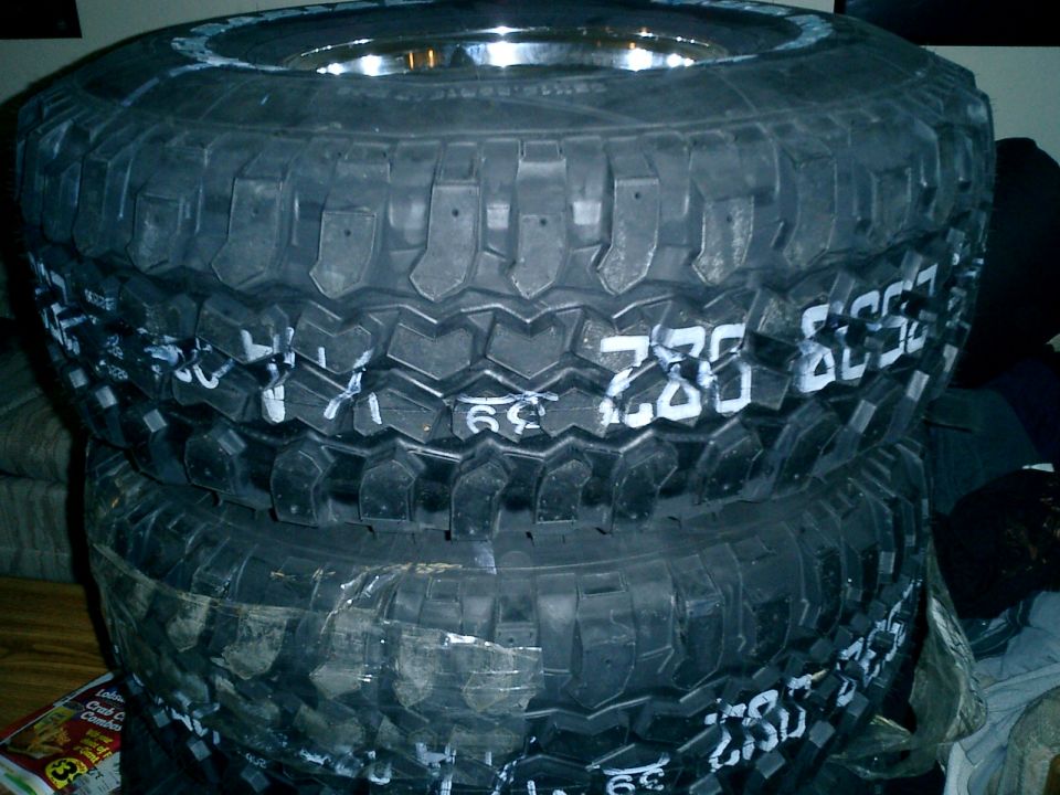 Stack of three off-road tires with white markings including '285/75R16' and '39'