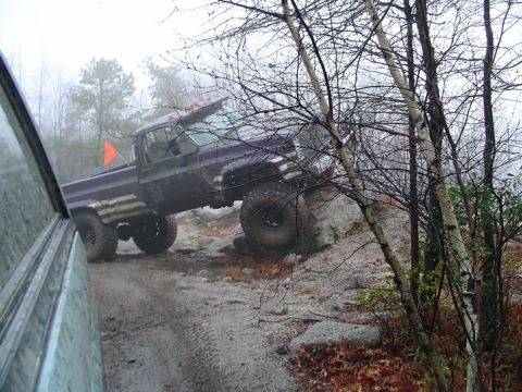1979 Ford Bronco - A lifted pickup truck navigates a rocky off-road course on a foggy day.