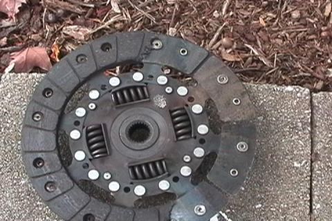 1996 Ford Bronco - A clutch disc, a critical component for manual transmissions, is shown resting on a textured surface.