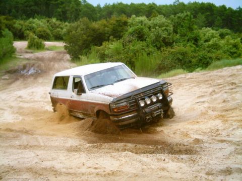1993 Ford Bronco - This 1992 Ford Bronco is stuck in the sand, its front tires partially submerged in the loose terrain.