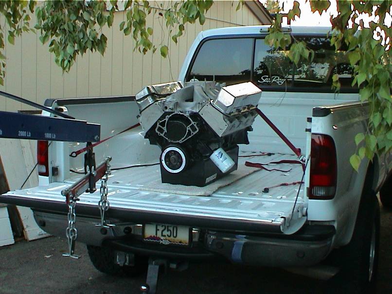 V8 short block with Moroso pan strapped in the bed of a white Ford F250 pickup