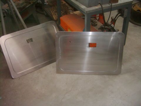 1978 Ford Bronco - Two brushed aluminum door panels are shown, one with a small orange reflector embedded in it.