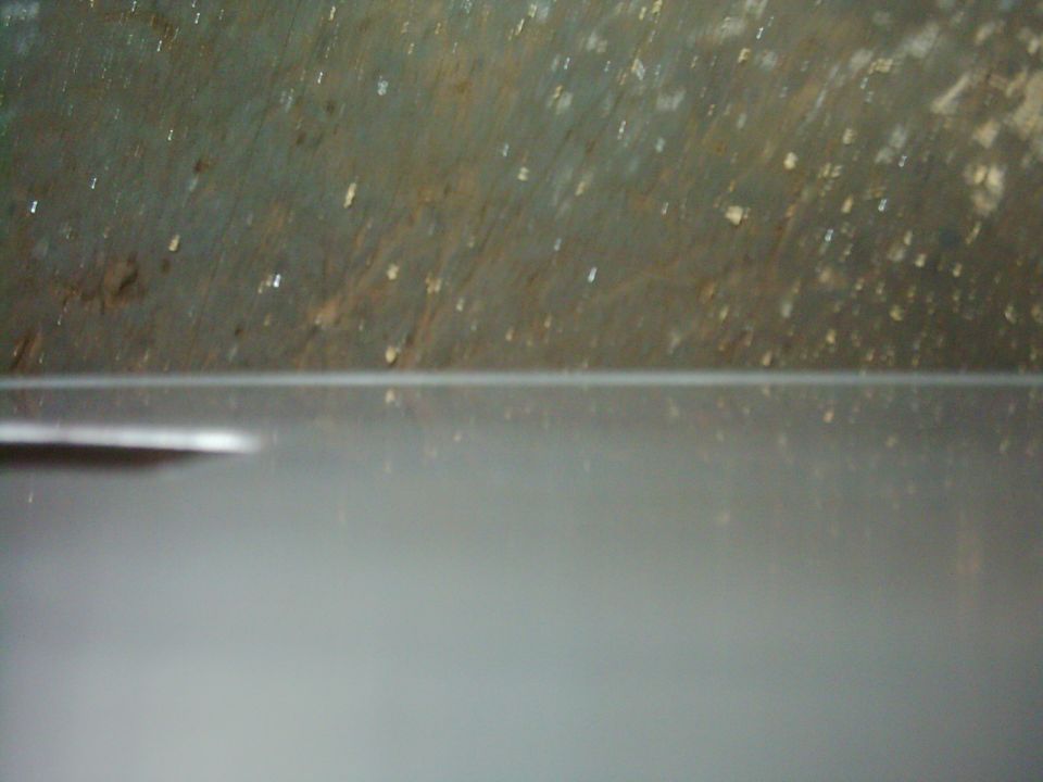 Gray door panel with textured upper section and a horizontal seam