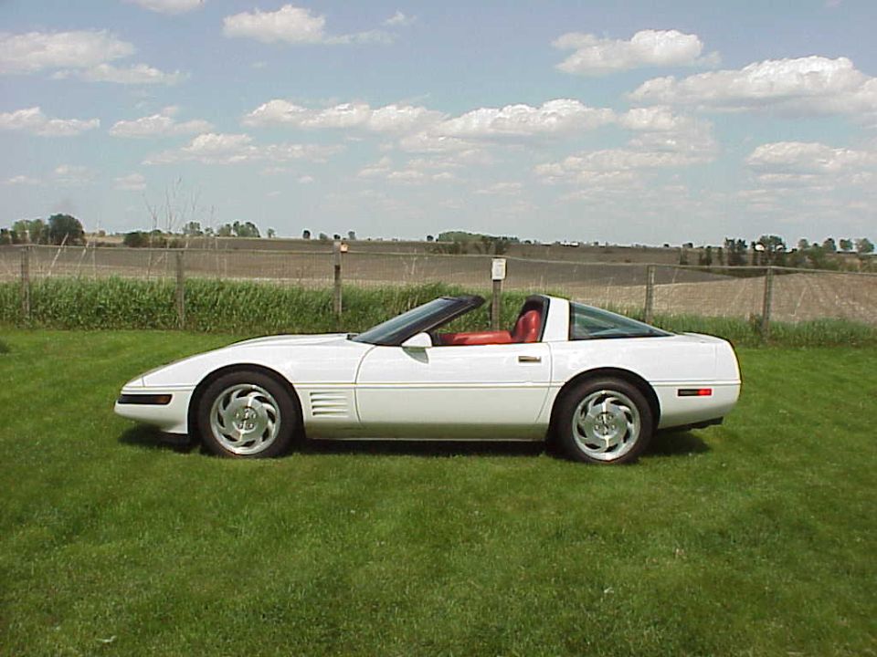 1994 Chevrolet Corvette, white exterior, red interior, parked on grass