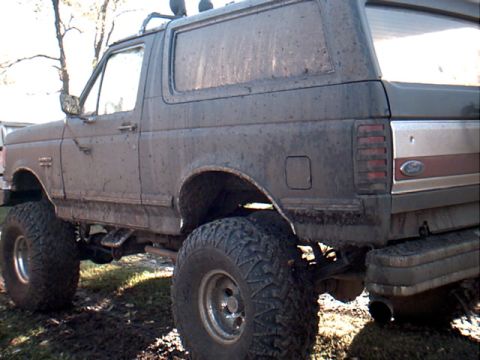 1990 Ford Bronco - This 1990 Ford Bronco is covered in mud and has been lifted with large off-road tires.