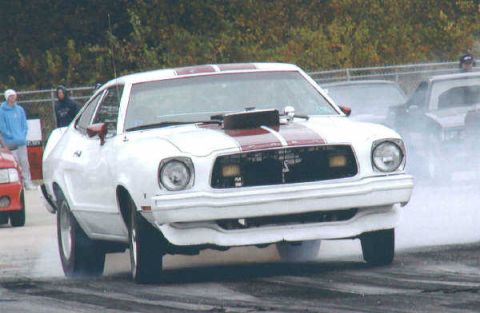 1976 Ford Mustang II - This 1976 Ford Mustang II is set up for drag racing, a prominent hood scoop and racing stripes.