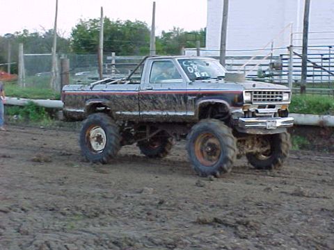 1987 Ford Ranger - This lifted 1987 Ford Ranger is covered in mud, suggesting it has been used for off-road activities.