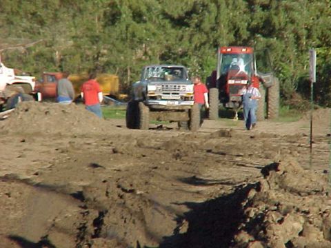 1987 Ford Ranger - A 1987 Ford Ranger is seen in a muddy area with a tractor in the background.