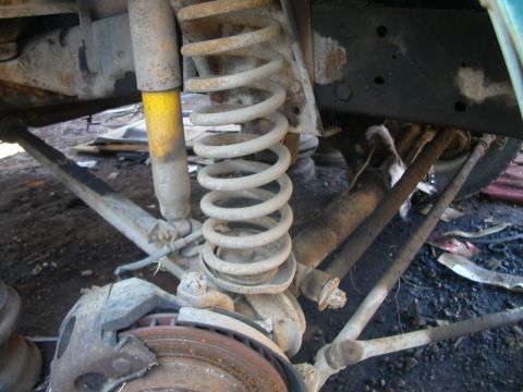1993 Ford Bronco - Front axle suspension components, including a coil spring and shock absorber, are visible in this close-up.