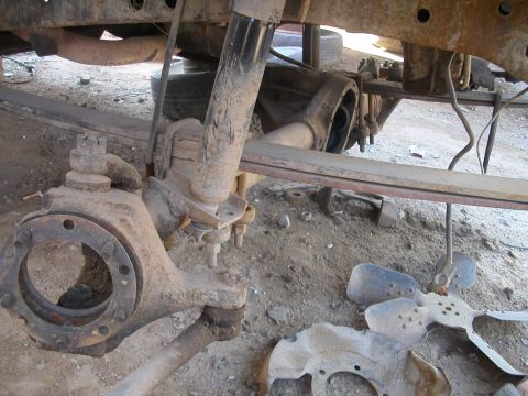 1993 Ford Bronco - Front axle and suspension components, likely from a truck or SUV, in a state of disrepair.