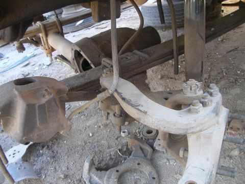 1993 Ford Bronco - The front axle assembly of a vehicle is shown, with various suspension components visible.
