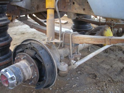 1993 Ford Bronco - Close-up of a vehicle's front axle assembly, including suspension and braking components.