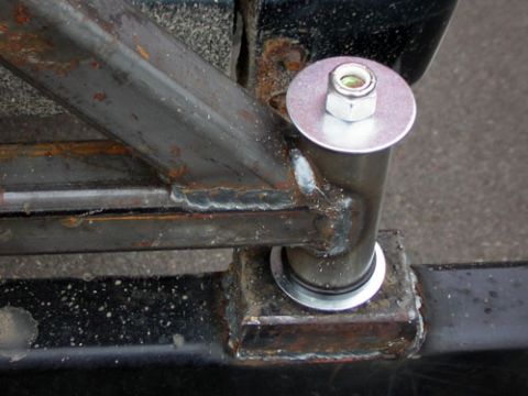 1995 Ford Bronco - Close-up of a custom bumper mount assembly, showing welded metal and a bolt with a washer and nut.