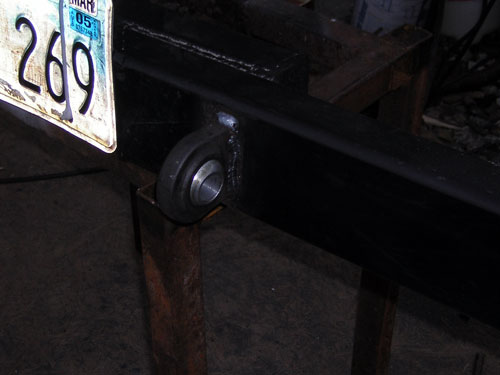 Welded steel bushing sleeve in a black square-tube bumper on a shop stand