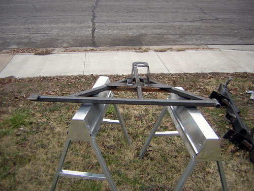metal trailer hitch frame on sawhorses