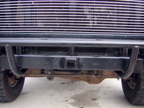 1995 Ford Bronco - Front view of a green 1992 Ford Bronco, showing its bumper, tow hitch, and grille.