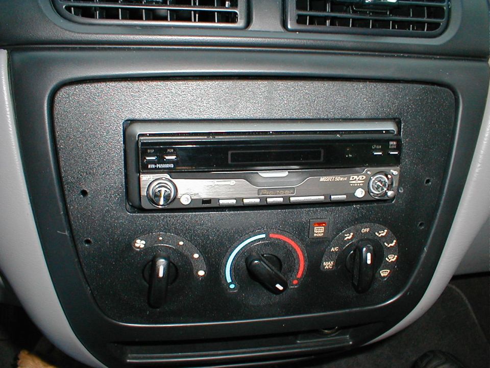 Car dashboard with aftermarket stereo, climate controls, and air vents
