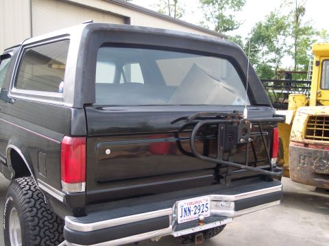 1989 Ford Bronco - The rear of a black Ford Bronco is shown with a spare tire mount and a Virginia license plate.