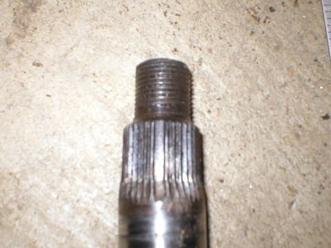 1978 Ford Bronco - This photo shows a metal shaft with splines and a threaded end, likely a mechanical component.