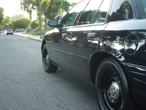 1999 Ford Crown Victoria - September 28, 2004 Passenger side front low close view.