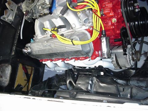 1958 Ford Custom Coupe - Engine bay detail a V8 engine with chrome valve covers and bright yellow spark plug wires.