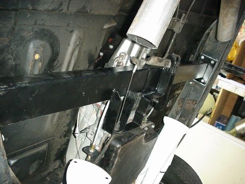 1958 Ford Custom Coupe - The underside of a vehicle shows a black frame, exhaust system, and fuel tank, with no clear year identification.