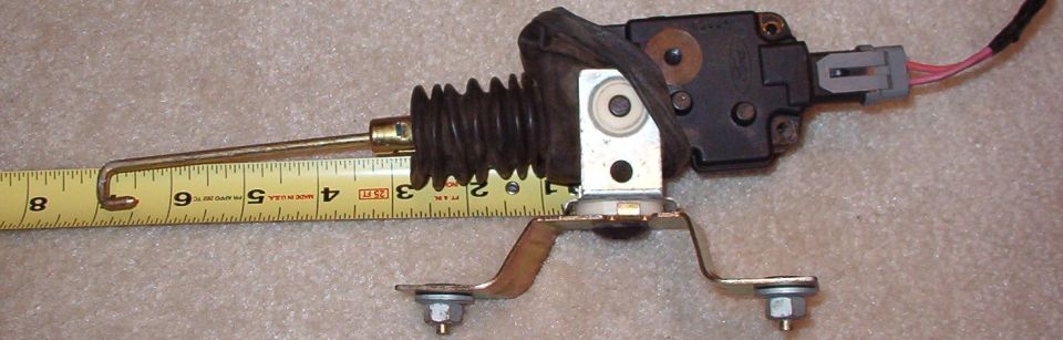 Late-model door lock motor. 8" when extended; gold mounting bracket & nuts shown are not included, but silver clip & pigtail are.

F-series & Broncos do not use the bridge bracket with 2 nuts; in trucks, the white (silver) lock motor yoke is riveted directly to the door skin.