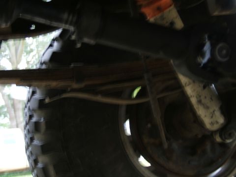 1978 Ford Bronco - Close-up of a vehicle's undercarriage, focusing on the suspension components and wheel.