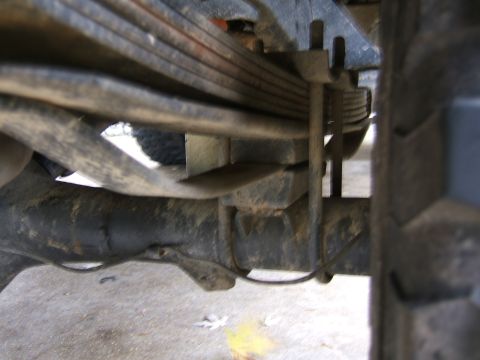 1978 Ford Bronco - Close-up view of the leaf spring suspension system on a vehicle's rear axle.