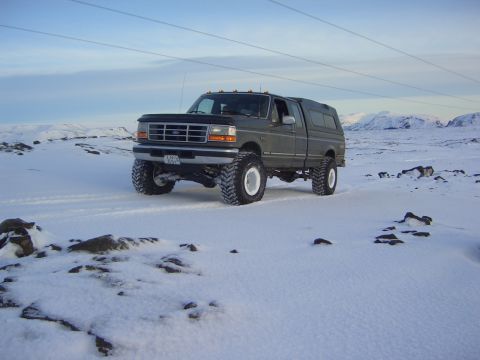 1996 Ford Bronco - This lifted 1992 Ford F-250 pickup truck is equipped with a camper shell and is driving in a snowy landscape.