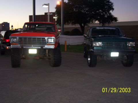 1989 Ford Bronco - Two lifted SUVs are parked side-by-side, one red and one green, with a date stamp of 01/29/2003 visible.