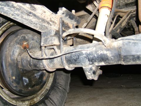 1978 Ford Bronco - This photo shows the rear axle and suspension components of a vehicle, including leaf springs and a shock absorber.