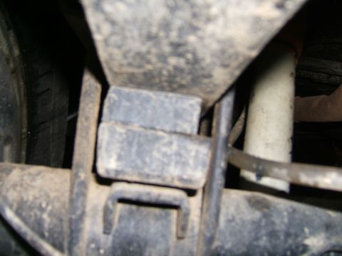 1978 Ford Bronco - Rear suspension components of a 1978 Ford Bronco, including the shock absorber and leaf spring assembly.