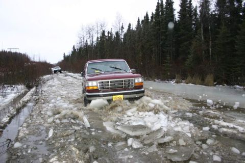 2003 Jeep TJ - A maroon 1995 Ford F-150 navigates a treacherous icy road, with another vehicle visible in the distance.