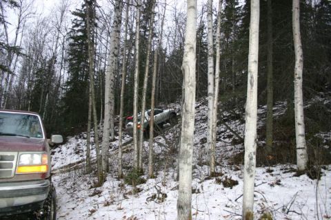 2003 Jeep TJ - Two vehicles navigate a challenging, snow-covered forest trail.